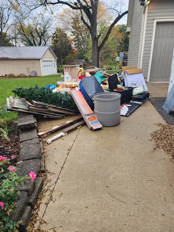 Dumpster being loaded with debris for Commercial Dumpster Rental in Sanford